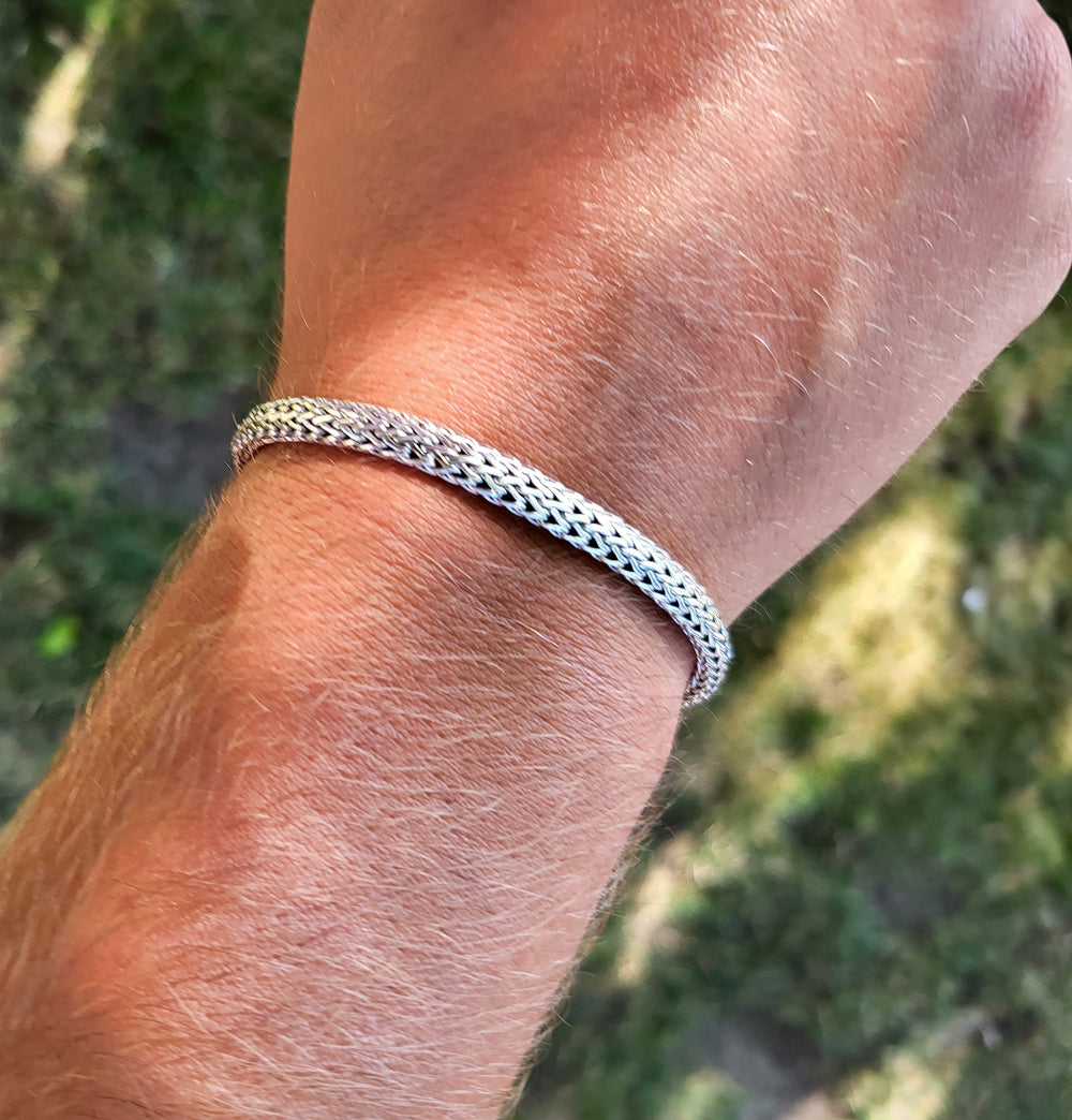 Young man wearing the woven bracelet.