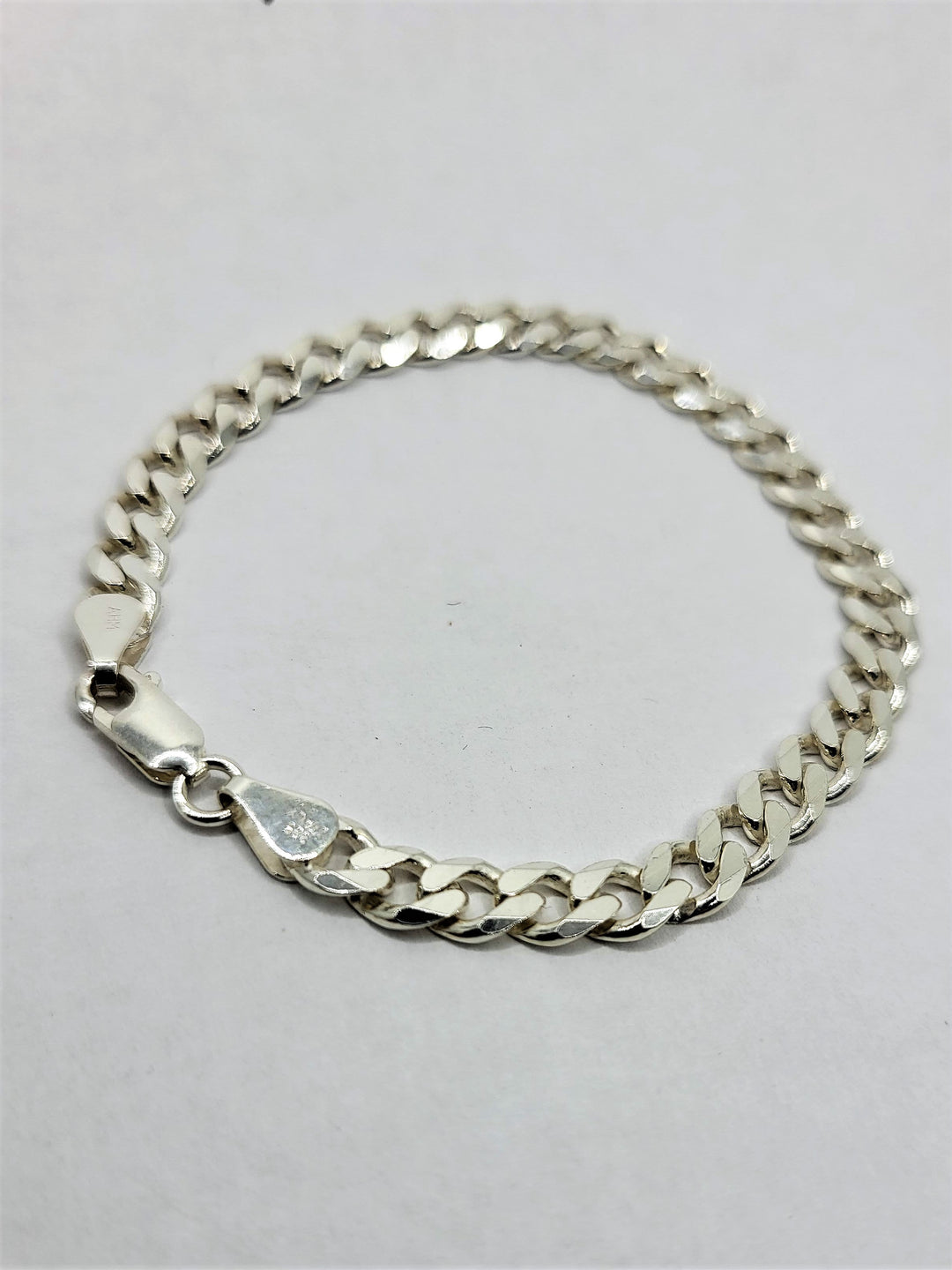 Sterling silver beveled curb chain bracelet.