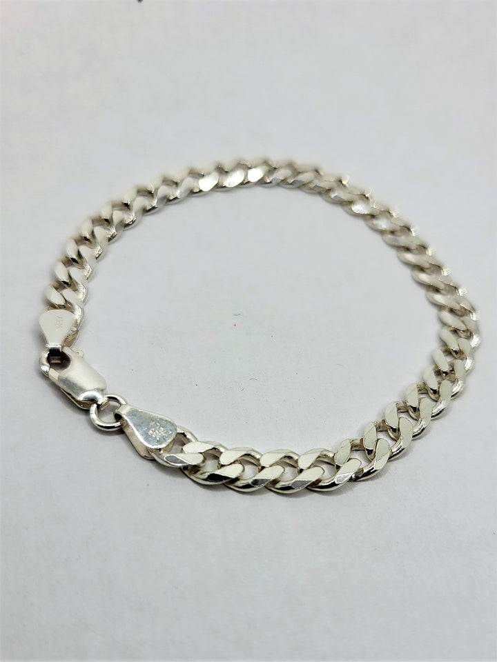 Sterling silver beveled curb chain bracelet.