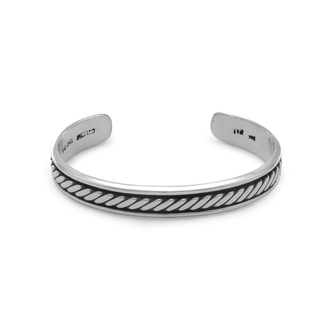 Indulge in the opulence of our Stud Muffin cuff bracelet, crafted from .925 sterling silver and boasting a striking rope design. Measuring approximately 62mm x 47mm wide, this piece exudes luxury and sophistication. The oxidized finish adds depth and character, while the polished silver gleams with a radiant shine. Pair with our other men's oxidized sterling silver jewelry for a truly elevated look.