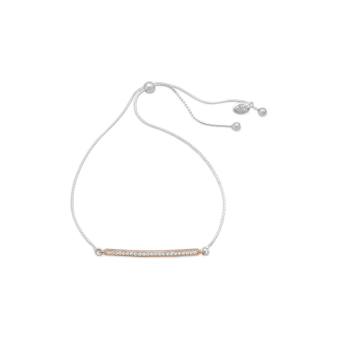 Indulge in the opulence of our adjustable sterling silver box chain bracelet, adorned with a 14 karat rose gold plated cubic zirconia bar. The bar's 2mm x 31mm size exudes elegance, while the 4mm sterling silver bead allows for a perfect fit up to 9.5". This exquisite piece is a perfect gift for a loved one and pairs beautifully with our other rose gold jewelry pieces. Crafted from .925 sterling silver, this bracelet is a true luxury statement.