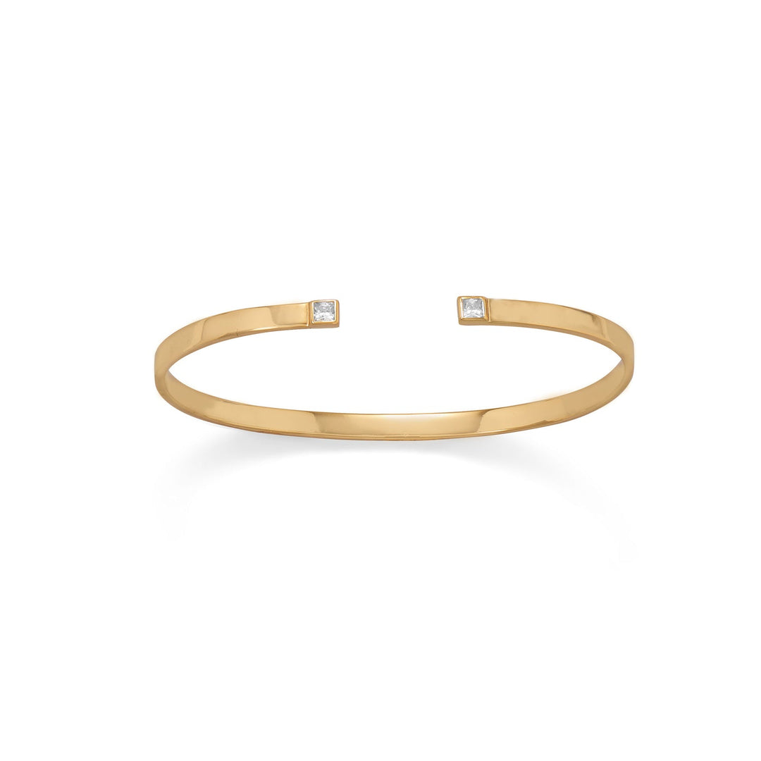 Indulge in opulence with our 14K gold plated sterling silver cuff, adorned with a stunning square cubic zirconia. The value of the gold plating and the beauty of the cubic zirconia are unmatched, while the unique square cut adds a touch of sophistication. Crafted from .925 sterling silver, this cuff measures approximately 60mm across and 3.5mm wide, making it the perfect statement piece for any occasion. Pair it with any of our other gold jewelry pieces for a truly luxurious look.