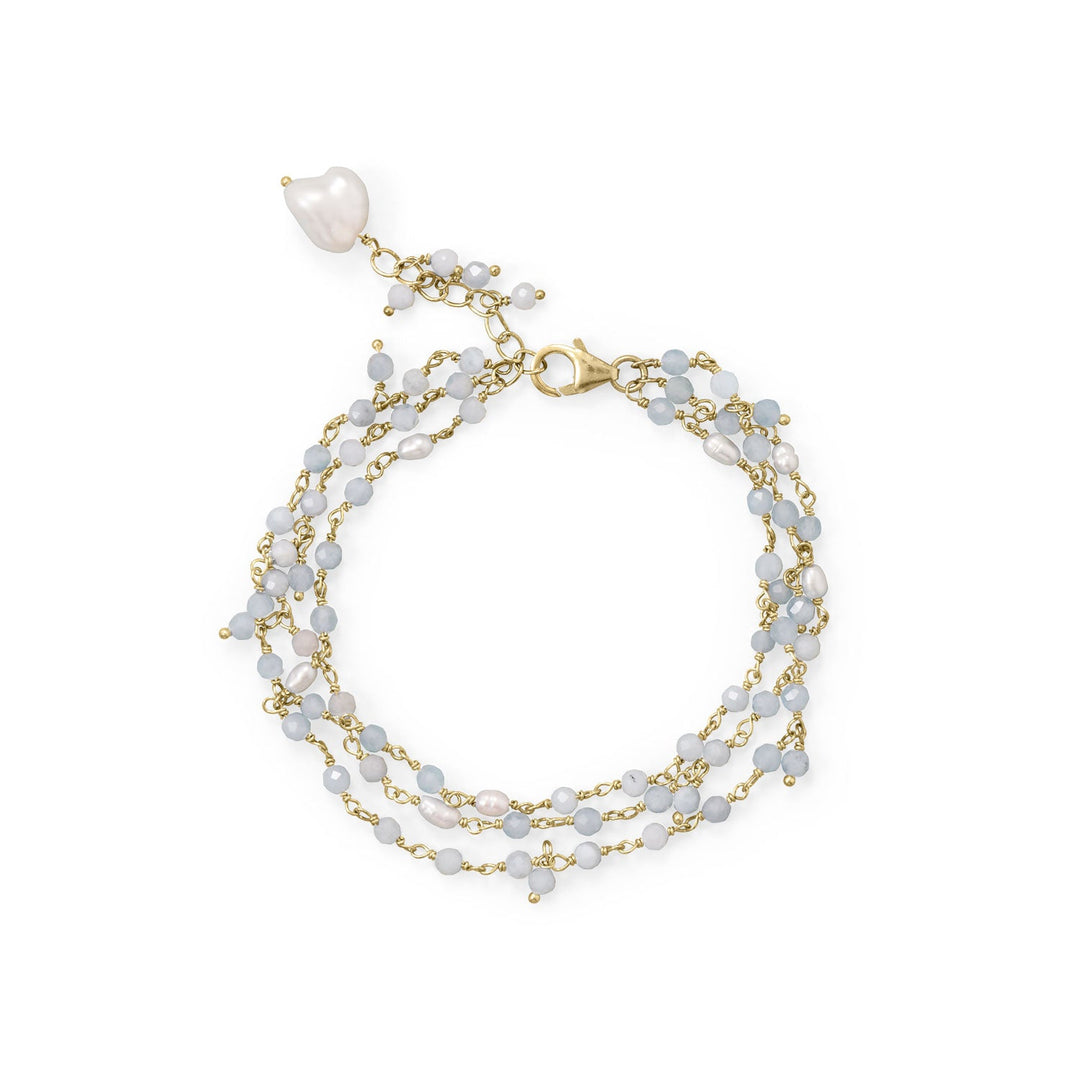 Our favorite icy bracelet, now in gold tone! 7" gold plated sterling silver three strand bracelet with 1" extension features aquamarine and cultured fresh water pearls. Beaded aquamarine and pearls measure 2.8-4mm and largest pearl measures approximately 8.8mm x 9.9mm. This bracelet features a lobster clasp closure. Stone and pearl sizes will vary slightly. .925 Sterling Silver