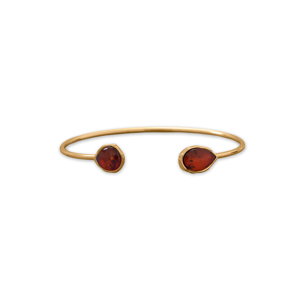 Amber - one of a kind and rich in color. 24 karat gold plated sterling silver cuff bracelet has pear-shaped genuine Baltic amber ends. Amber measures 12mm x 7mm and 8mm x 9mm. Genuine Baltic amber is from Poland .925 Sterling Silver
