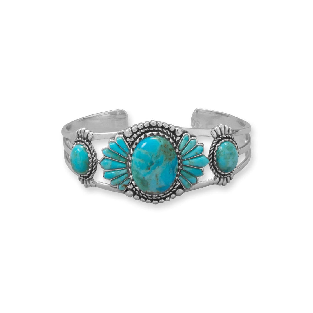 All eyes will be on you! Oxidized sterling southwest style silver cuff bracelet features deco detailing and rich, vibrant reconstituted turquoise. The center stone measures 20mm x 15mm and is edged with fancy cut stone, accent oval stones measure 8mm x 10mm. .925 Sterling Silver