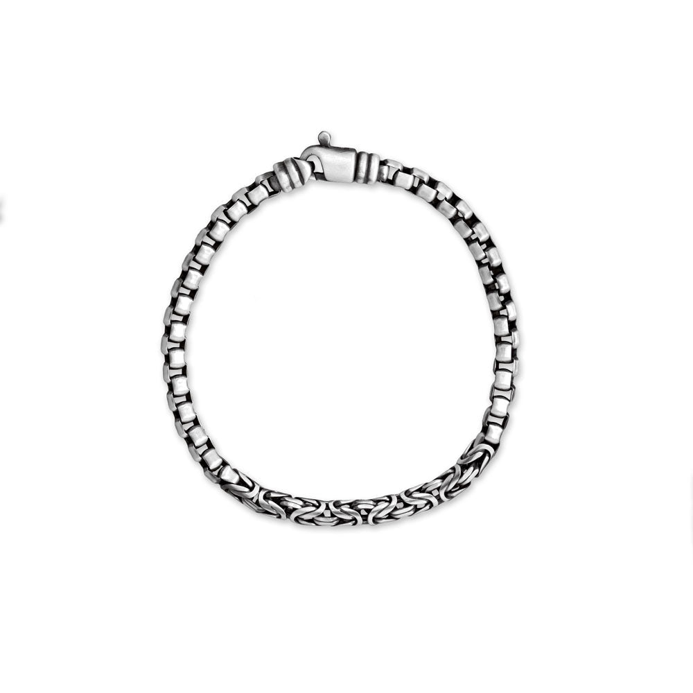Introducing the epitome of elegance for the discerning gentleman. Meticulously handcrafted in Italy, this exquisite bracelet effortlessly blends the timeless allure of 5mm Byzantine and box chains. The black rhodium brushed sterling silver exudes a masculine charm, while the 8.5" length ensures a perfect fit. Completed with a swivel lobster clasp for utmost convenience, this masterpiece is a testament to impeccable craftsmanship.