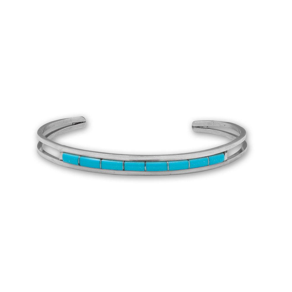 A simple yet sleek, handmade Navajo bracelet. Native American artist Running Bear handcrafted sterling silver turquoise cuff is 6.1mm wide and features eight 6mm x 3mm Kingman stabilized turquoise stones. Inside diameter measures 60mm. Each cuff has R.B. inside a bear outline hallmark to show its' authenticity..925 Sterling SilverMade in the USA.