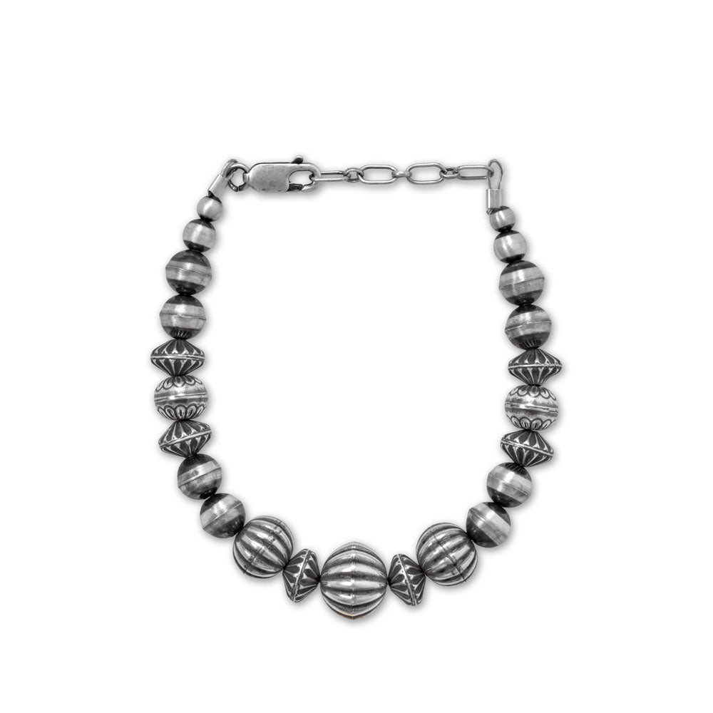 Traditional, timeless style. 6.5" + 1" sterling silver southwest-inspired bracelet is created using assorted oxidized beads that are handmade in the USA. The graduated beads range from 11mm to 4mm and the bracelet is finished with a lobster clasp closure. .925 Sterling Silver Made in the USA.