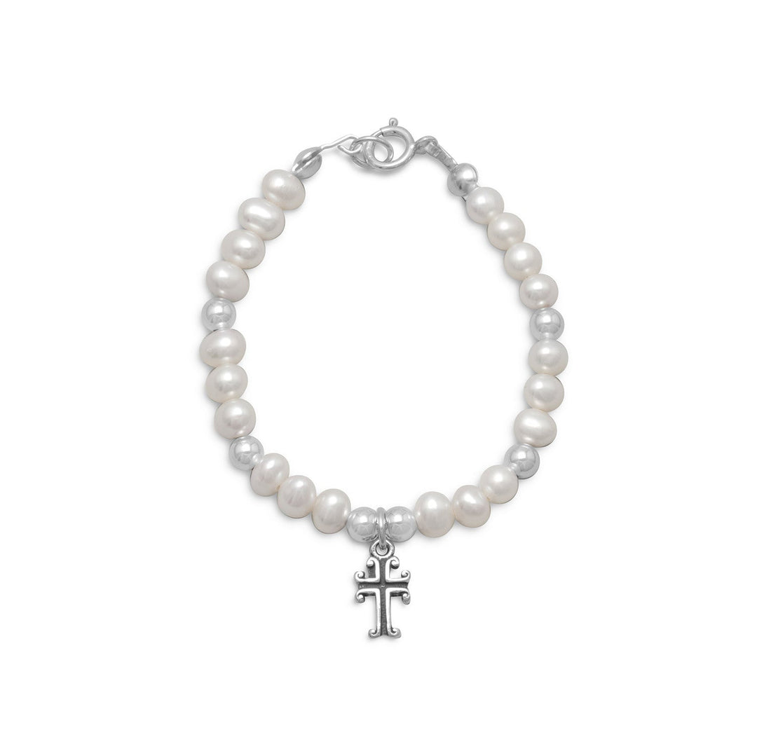 The Pearl and Silver Bead Bracelet. is crafted from .925 sterling silver, and boasts a delicate design. The bracelet features cultured fresh water pearls and silver beads that measure approximately 4mm in diameter, creating a beautiful contrast . At the center of the bracelet lies an 8mm x 6mm cross, which adds a touch of symbolism and meaning to the piece. The oxidized finish of the cross further enhances its beauty,