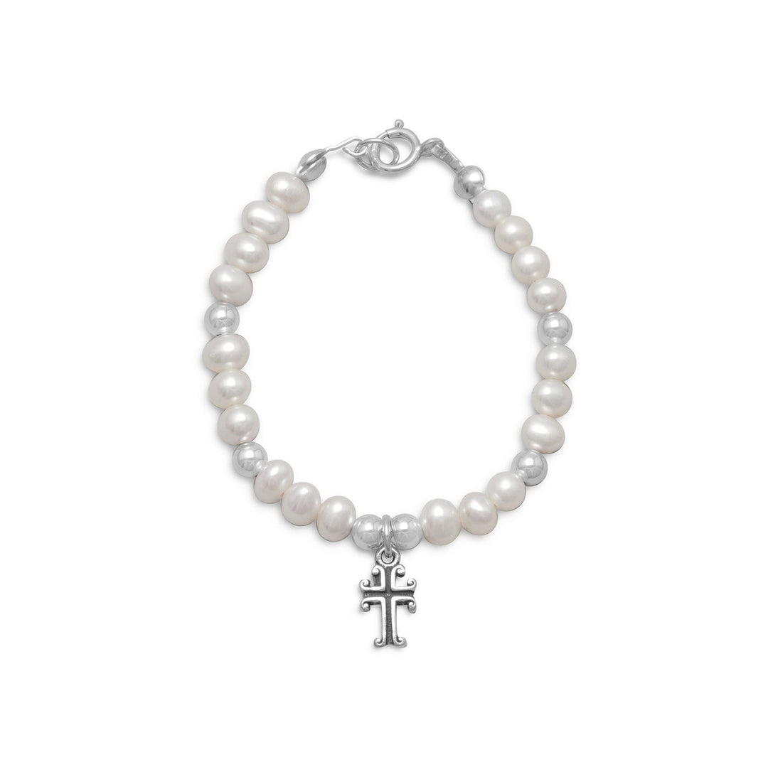 The Pearl and Silver Bead Bracelet. is crafted from .925 sterling silver, and boasts a delicate design. The bracelet features cultured fresh water pearls and silver beads that measure approximately 4mm in diameter, creating a beautiful contrast .  At the center of the bracelet lies an 8mm x 6mm cross, which adds a touch of symbolism and meaning to the piece. The oxidized finish of the cross further enhances its beauty,