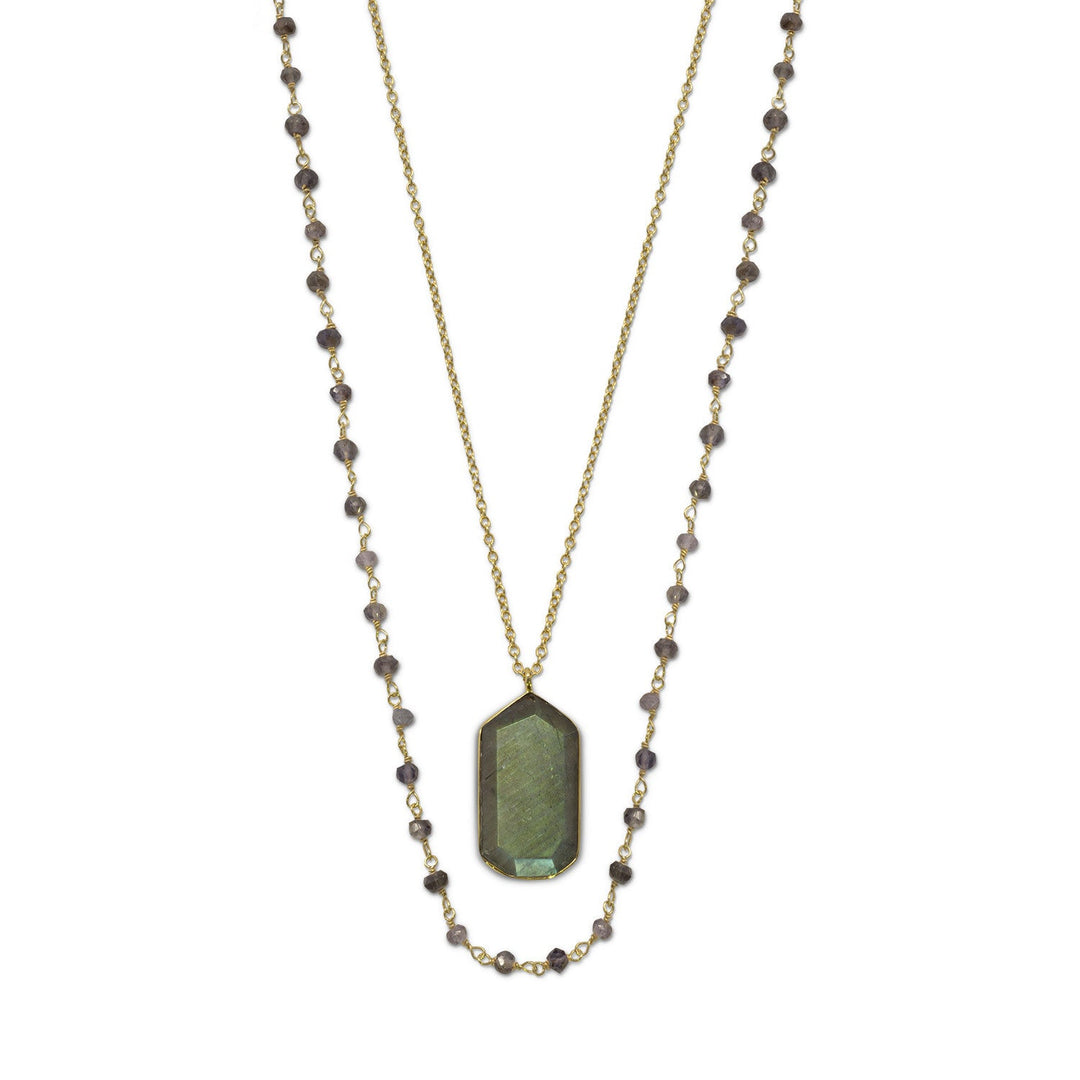 Introducing our exquisite 35" strand of faceted iolite on 14 karat gold plated wire, accompanied by a 30" chain with a captivating labradorite drop. The alluring labradorite, measuring approximately 14.5mm x 25mm, is encased in a luxurious gold double strand necklace. Finished with a lobster clasp closure, this .925 Sterling Silver masterpiece is the perfect gift for a cherished individual.