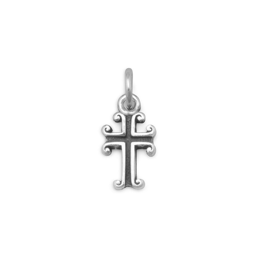 Crafted from .925 sterling silver, this charm boasts a unique oxidized finish that adds to its allure and beauty. Measuring approximately 6.5mm x 9mm, the cross is delicately designed to showcase its intricate details and symbolism. The charm itself measures 6.5mm x 15mm, making it a perfect addition to any of our sterling silver necklaces. Its versatile size and design make it an ideal accessory for any occasion, whether it be a formal event or a casual outing.