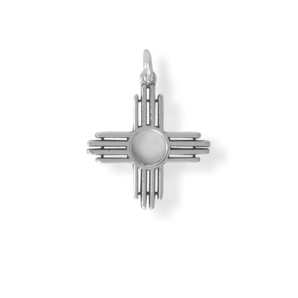 An important symbol in the Pueblo community, this 18.8mm oxidized Zia charm has many meanings: The four cardinal directions, the four seasons of the year, the four periods of the day, and the four steps of life. The circle in the middle ties the rays together to represent love and life. .925 Sterling Silver