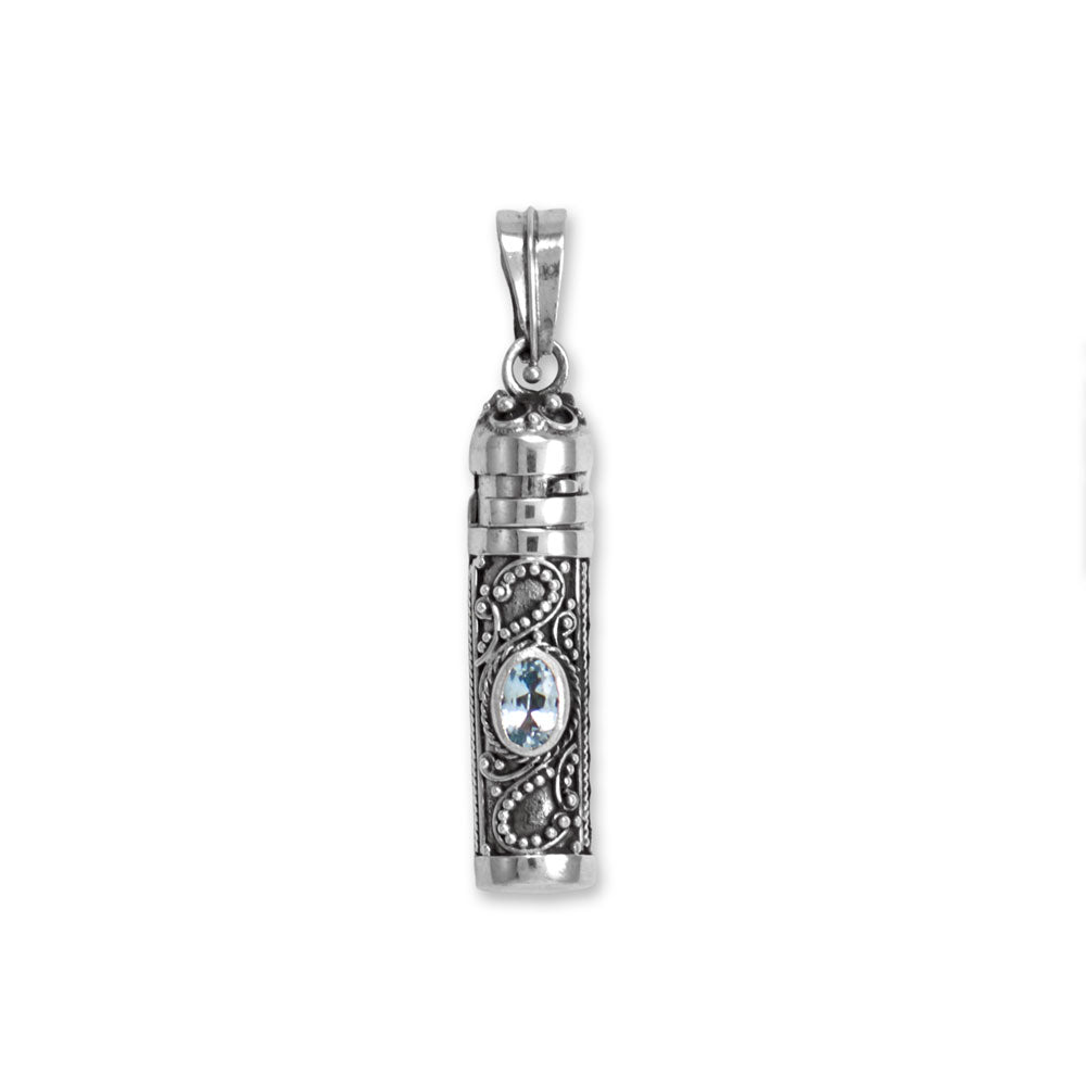 Perfect for storing tender tokens like cremains, a lock of hair, or even a tiny note/prayer. Oxidized sterling silver urn pendant measures 30mm x 8mm and features 6.0mm x 3.5mm blue topaz and artistic accents. Handmade items will have slight variances.   Handcrafted in exotic Bali, Indonesia 