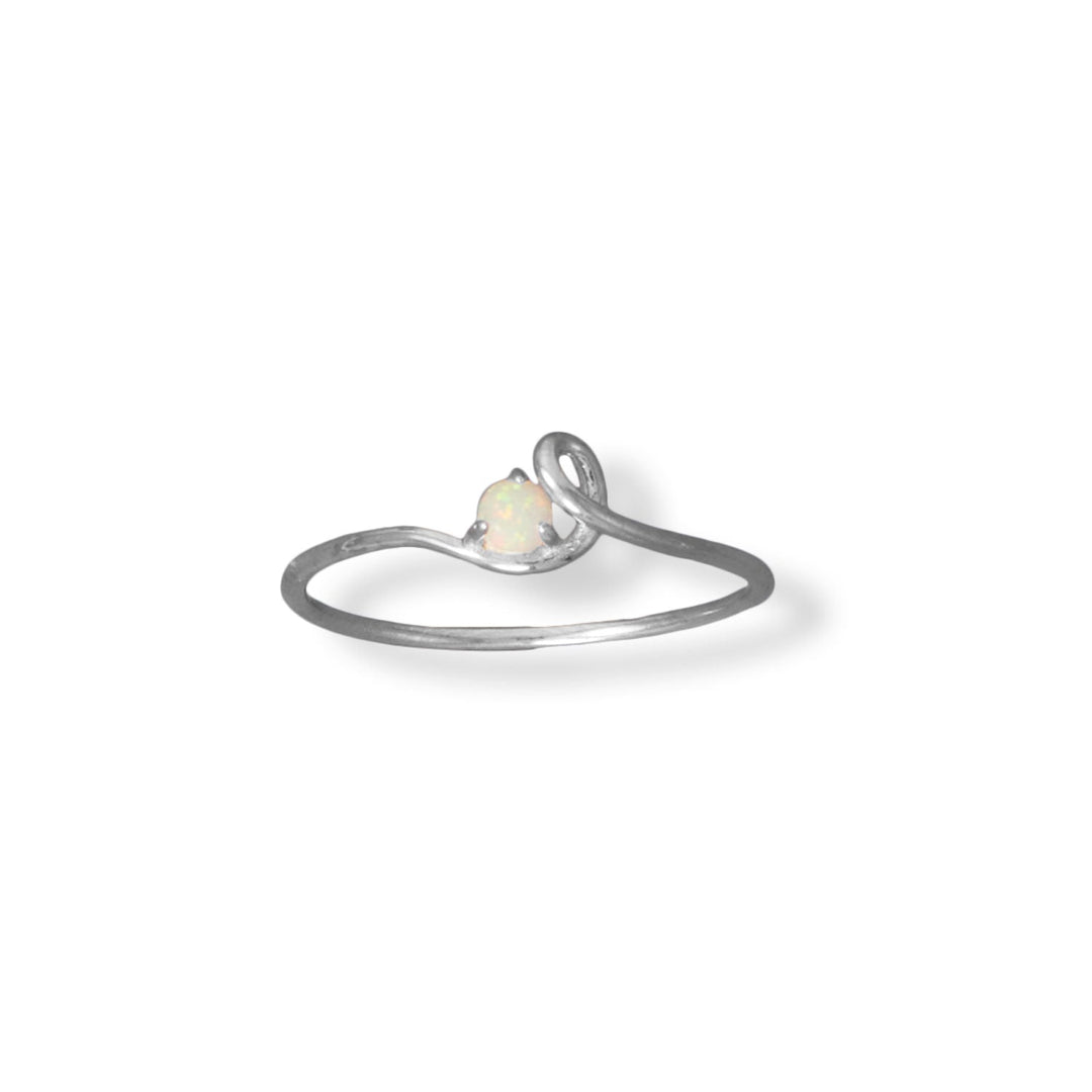Indulge in the opulent allure of this exquisite ring, crafted from the finest .925 sterling silver. With its unparalleled value and enduring durability, this piece is sure to become a treasured addition to your collection. Adorned with a 3mm synthetic opal and a stunning loop-design band, this dainty ring is the epitome of luxury. Available in whole sizes 4-9, it pairs perfectly with our other sterling silver and opal jewelry for a cohesive and complete look.