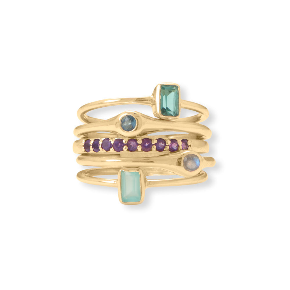 Wear one, wear them all - this fun and funky stack of rings will be your go-to every day! 14 karat gold plated sterling silver ring set has five individual rings featuring a 2mm amethyst, 3mm labradorite, 3mm blue glass, 5mm x 3.5mm green glass, and 5mm x 3.5mm aqua glass. Bands width varies from 1.4mm-2mm. Available in whole sizes 6-9. .925 Sterling Silver