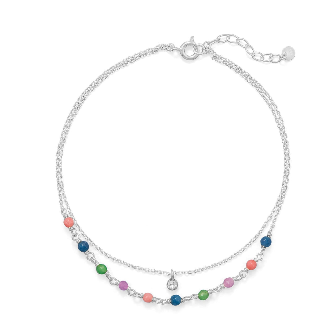 Introducing our beautiful 9"+1" double strand anklet. It has multi-colored 3mm faceted dyed jade on one strand and a floating 3.5mm clear crystal on the other. Made from .925 sterling silver, it's both stylish and valuable. The spring ring closure ensures a secure fit. Add a touch of elegance and sparkle to your ankle with this must-have accessory.