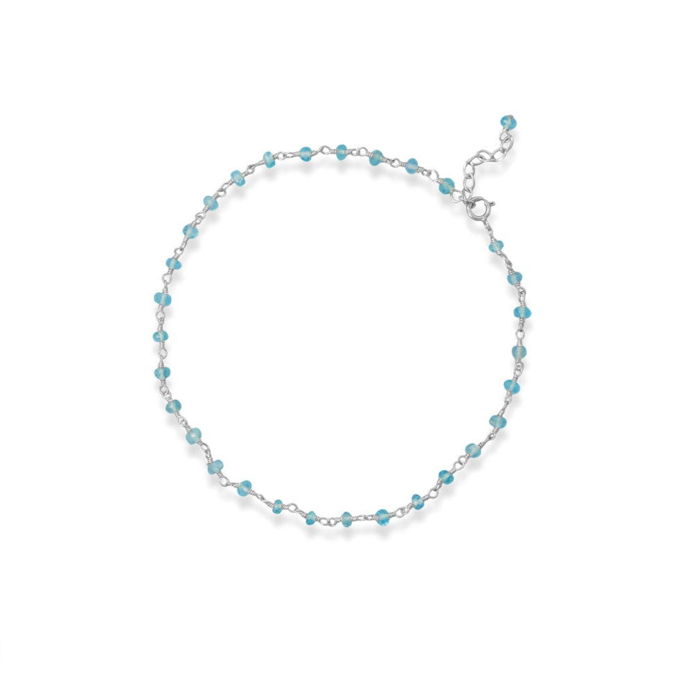 Get captivated by our Sterling Silver Hand Beaded Chain Anklet with beautiful Apatite beads. Perfect for any occasion. Apatite beads are believed to promote creativity, self-expression, and communication, making them a valuable addition to any jewelry collection. The beauty of the sea breeze blue color of the Apatite beads is truly mesmerizing, and is perfectly complemented by the .925 Sterling Silver chain