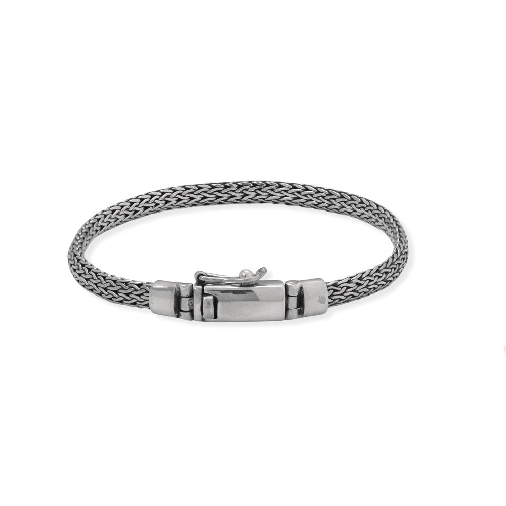 Subtle, simple, and a staple for anyone! 8" oxidized sterling silver woven bracelet with a box clasp. The bracelet is 5mm wide and features a hinged box clasp with safety catch.<br>Made in Bali, Indonesia<br>.925 Sterling Silver