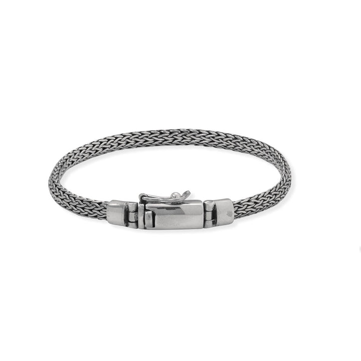 Subtle, simple, and a staple for anyone! 8" oxidized sterling silver woven bracelet with a box clasp. The bracelet is 5mm wide and features a hinged box clasp with safety catch.<br>Made in Bali, Indonesia<br>.925 Sterling Silver