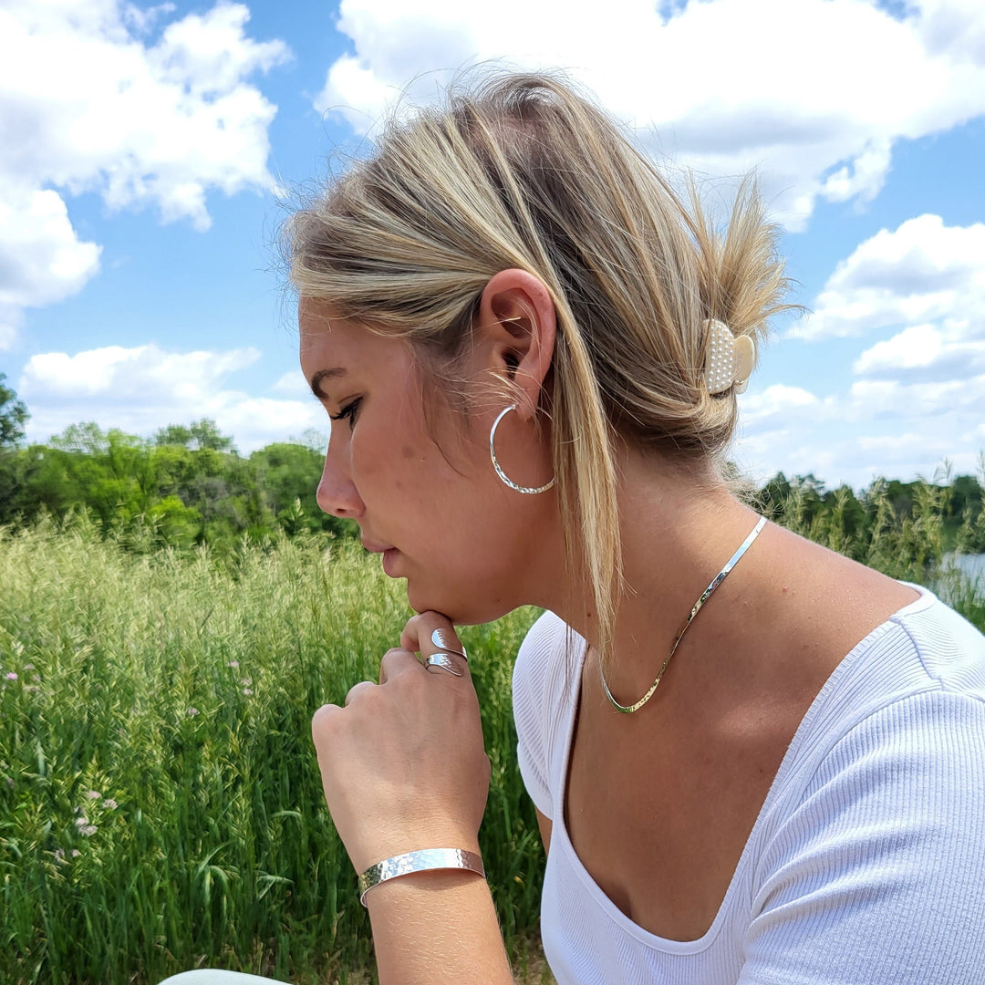 Introducing our exquisite Hammered Sterling Silver jewelry collection that effortlessly captivates onlookers. Its ethereal weightlessness complements flawlessly with our other stunning hammered silver pieces.