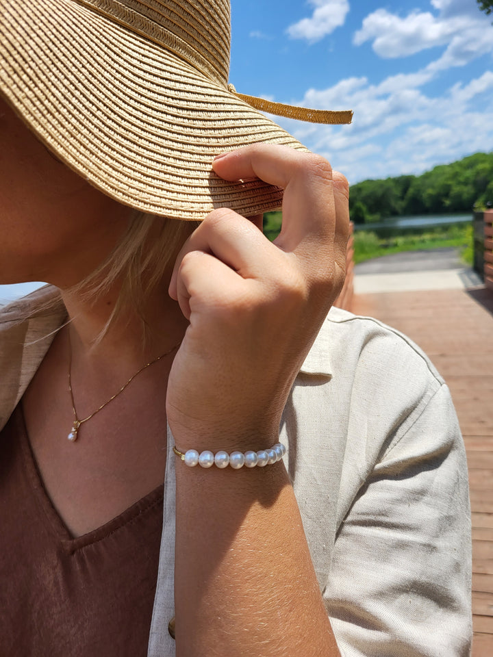 Young lady wearing the gold and pearl bolo bracelet