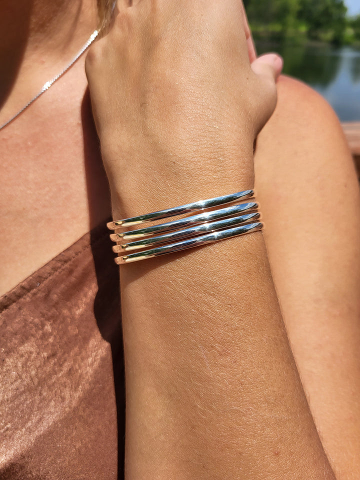 Woman wearing the 4 row polished cuff outside.