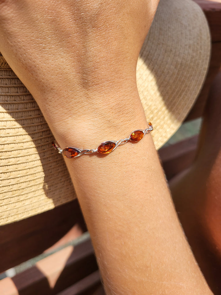 Introducing our stunning 7" sterling silver cutout bracelet with genuine Baltic amber. A timeless beauty.