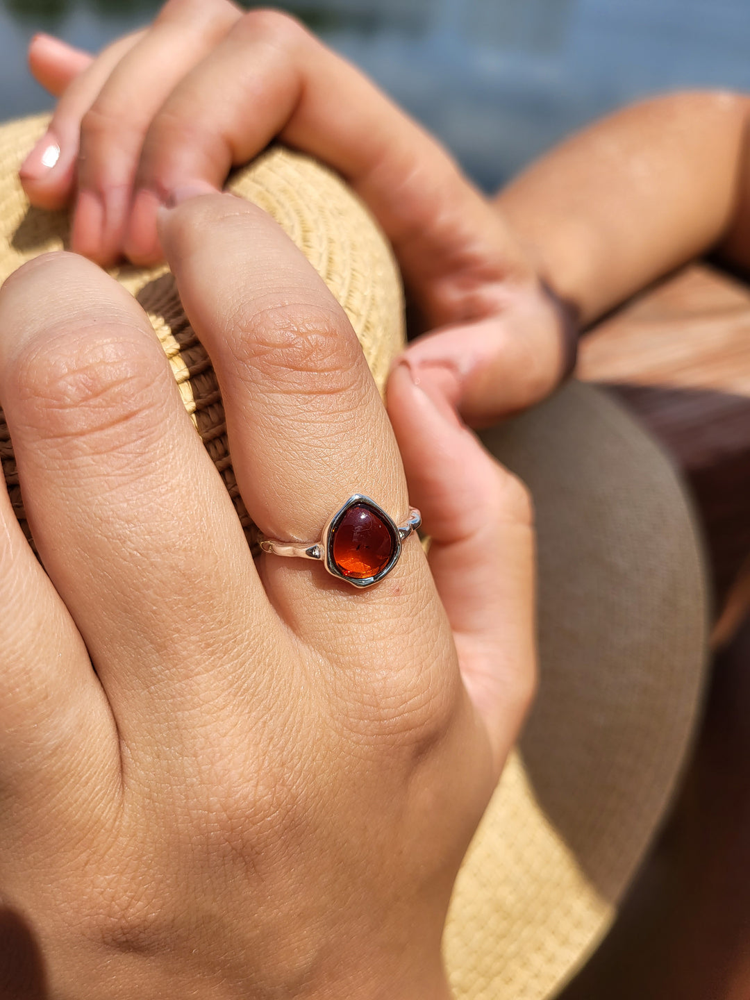 Indulge in the opulence of our sterling silver ring, adorned with a genuine Baltic amber from Poland. The pear shape gem is elegantly complemented by a hammered texture band. Available in sizes 5-9, this piece is a must-have for the discerning connoisseur. Complete your ensemble by pairing it with our other sterling silver and Baltic Amber jewelry pieces.