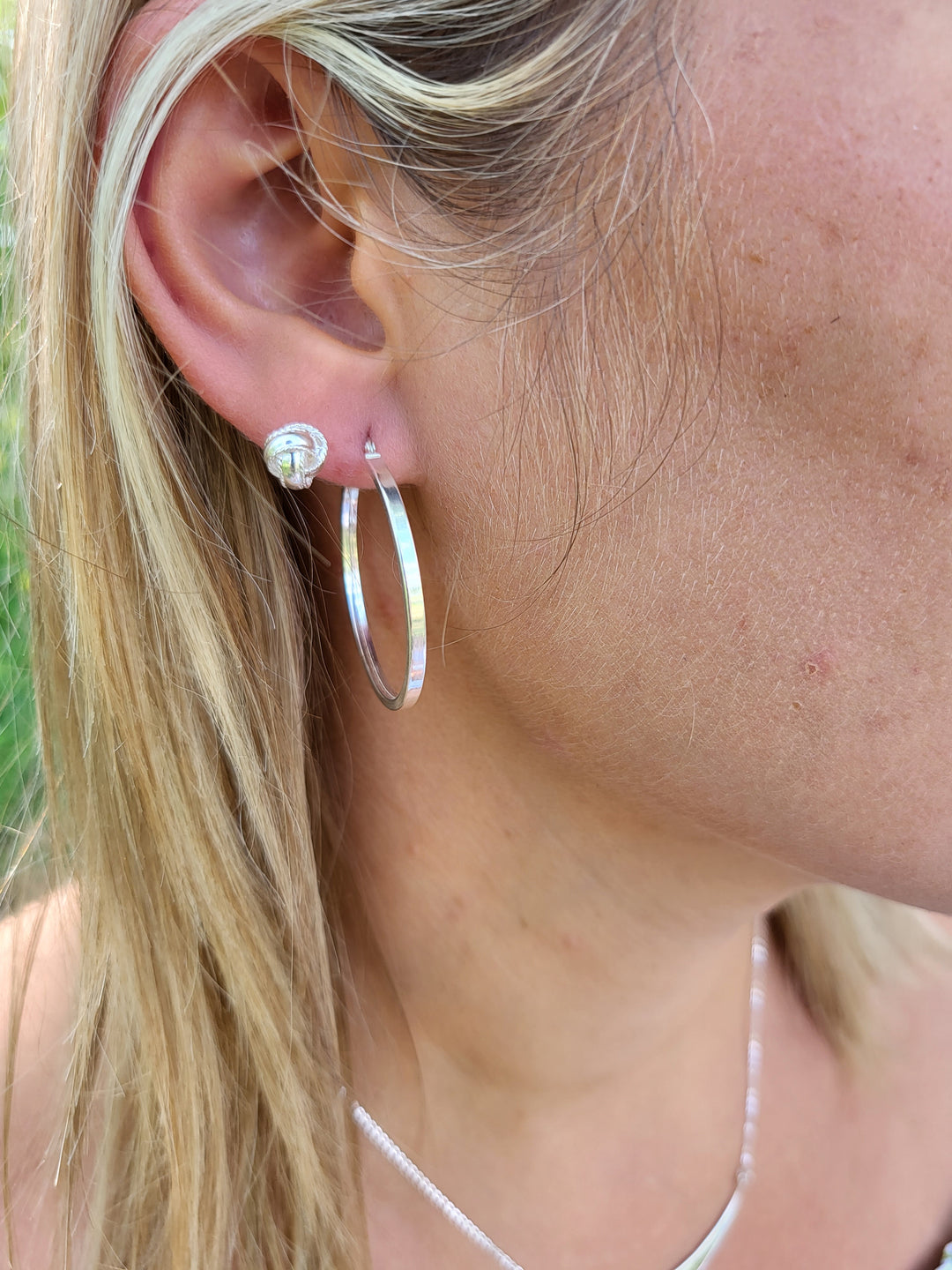 The Love Knot earrings on young woman.