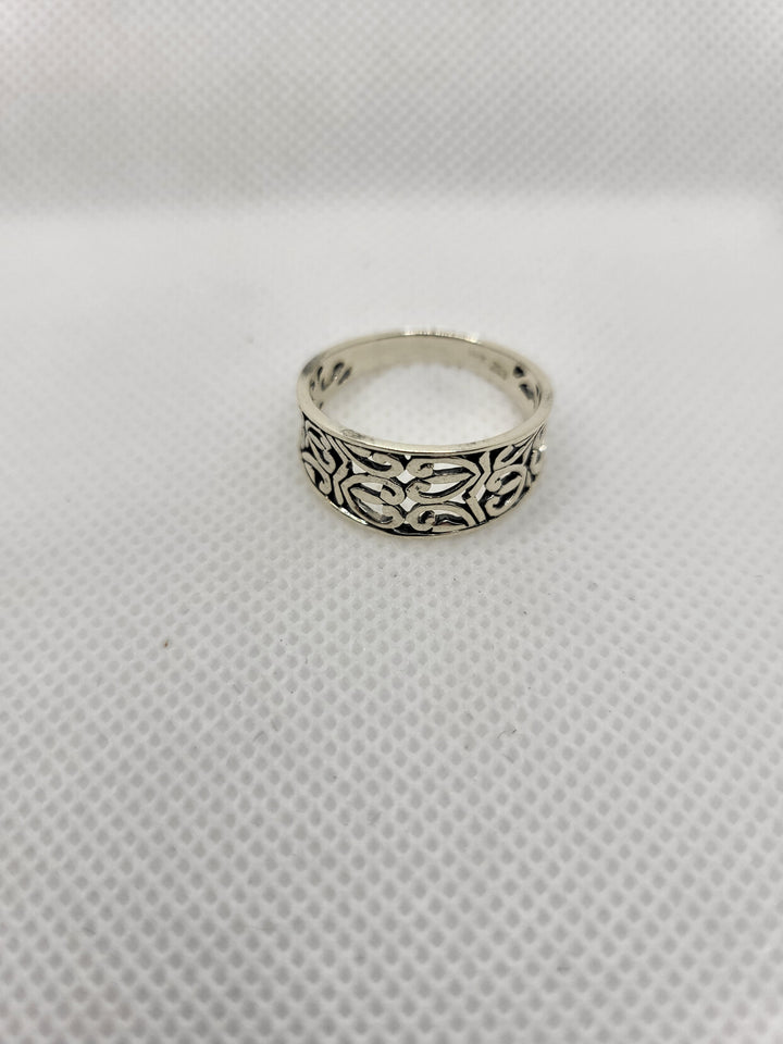 Experience the epitome of luxury with our stunning oxidized sterling silver cut out heart design ring. Meticulously crafted with Celtic-inspired heart cut outs and a tapered band, this piece exudes elegance. Available in sizes 5-9, it pairs perfectly with our other oxidized sterling jewelry collection pieces. Made with .925 sterling silver, this ring is a must-have addition to any discerning jewelry collection.