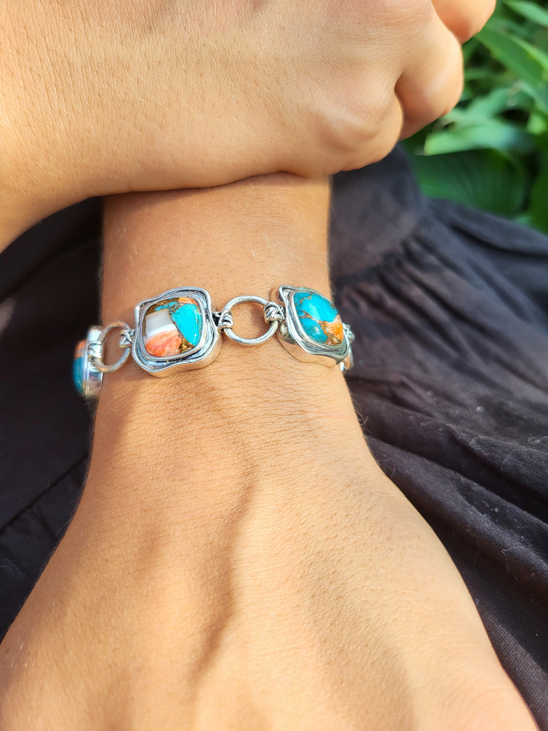 Indulge in opulence with our Exquisite Elegance toggle bracelet, a mesmerizing work of art crafted from .925 sterling silver, embellished with rare spiny oyster and turquoise cushion cut compressed stones. Immerse yourself in the epitome of refined luxury and sophistication.