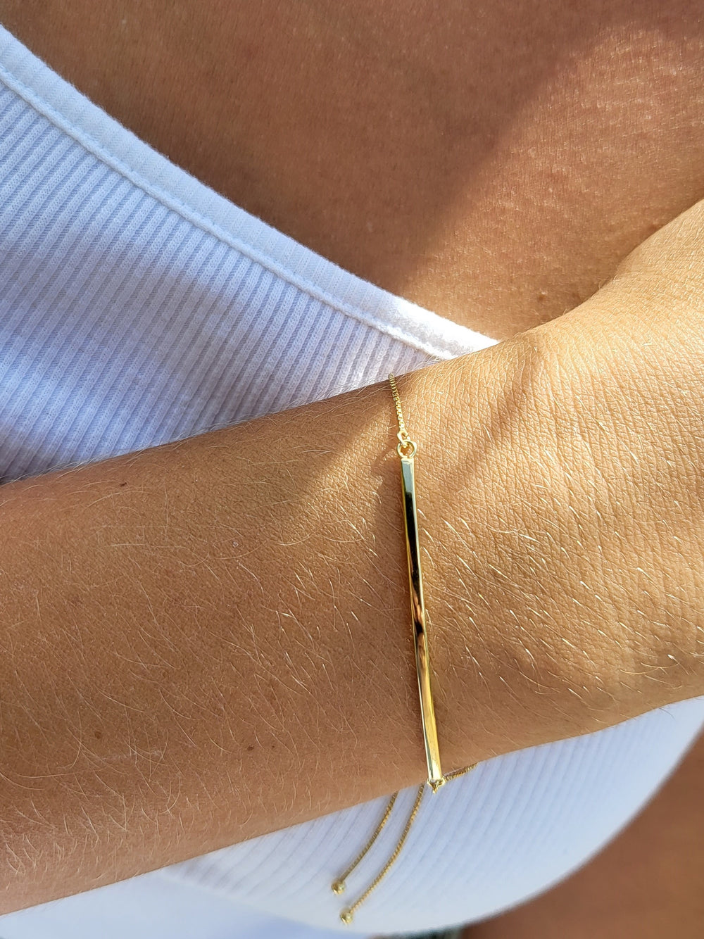 Young lady modeling the Gold Bar Bolo Bracelet