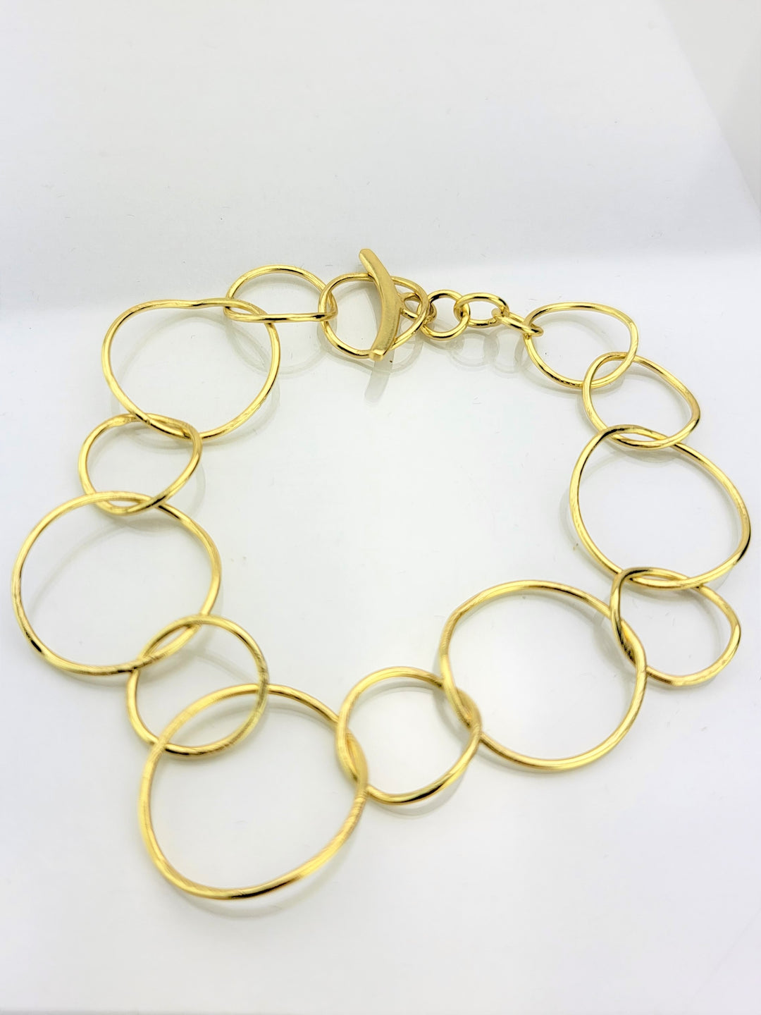 Introducing our exquisite 14k gold plated toggle bracelet, a must-have for fashionistas. Adjustable and eye-catching, it complements our gold circle link collection flawlessly.