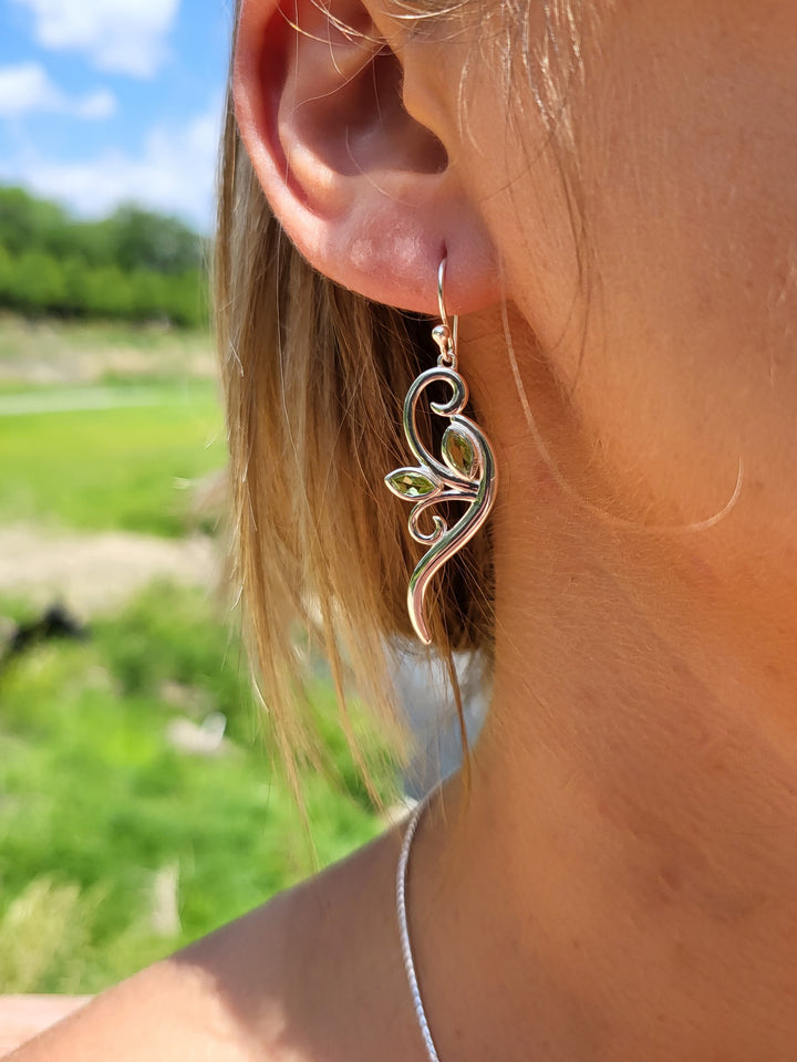 Get ready to turn heads with our stunning sterling silver peridot leaf earrings. Unforgettable elegance assured.