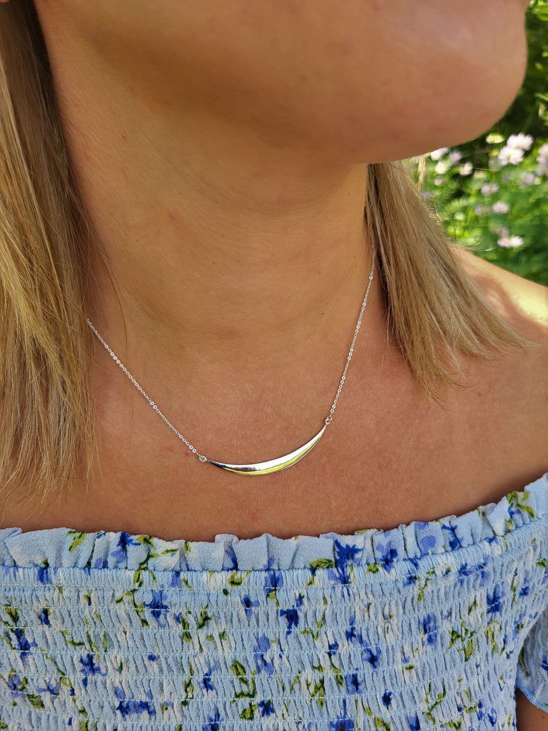 Introducing our Classic Style Sterling Silver Necklace. Elevate your style with this must-have piece. The stunning crescent reflects light, adding sophistication to any outfit. Made from durable .925 Sterling Silver, it's adjustable and pairs perfectly with our other sterling silver jewelry. Make a statement today.