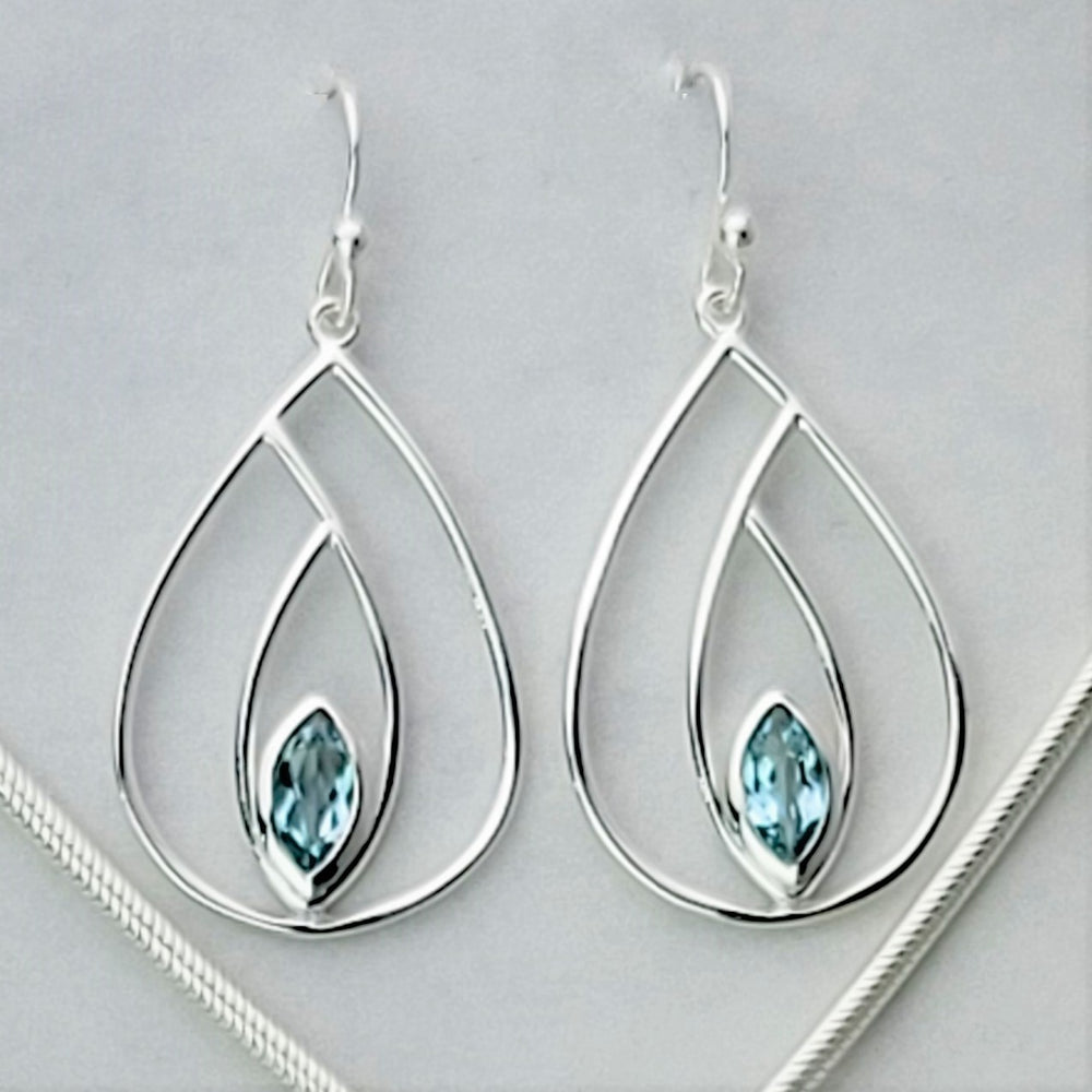 Elevate your fashion game with our chic and sophisticated French wire earrings. Featuring a stunning blue topaz pear design, these sterling silver earrings are a timeless addition to any outfit. Pair them with our other topaz jewelry pieces for a complete look. A must-have for the discerning connoisseur.