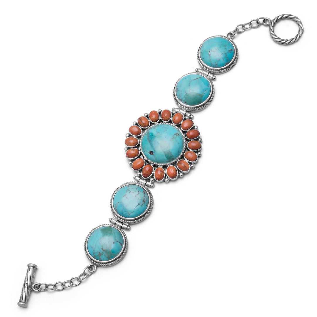 7.5" oxidized sterling silver toggle bracelet with reconstituted turquoise and orange coral sunburst design. There are 4 turquoise stones that are approximately 16mm. The center turquoise stone is 18mm, and is surrounded by 5mm x 6mm orange coral..925 Sterling Silver