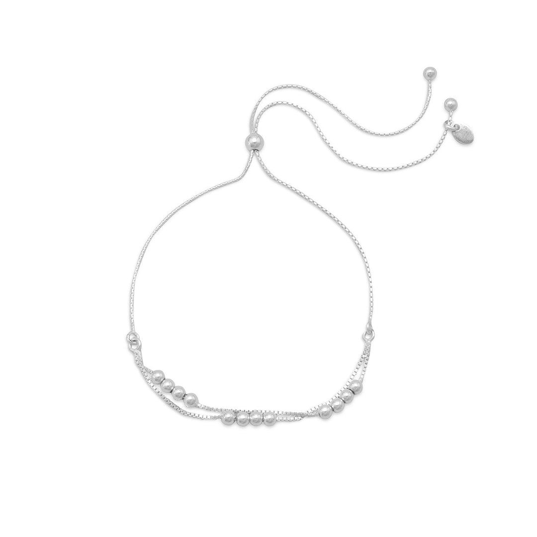 Indulge in the opulence of our adjustable double strand sterling silver box chain bracelet, adorned with 3mm beads and a 4mm sterling silver bead. Perfectly crafted to adjust to 11", this exquisite piece is a luxurious gift for your beloved. Pair it with our other sterling silver multi-strand jewelry pieces for a truly stunning ensemble. Made with .925 Sterling Silver, this bracelet is a timeless treasure that will last a lifetime.