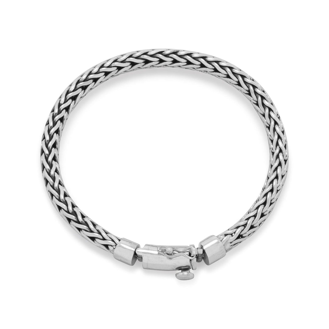 Subtle, simple and a staple for anyone! 8" oxidized sterling silver woven bracelet has a hinged box clasp with safety catch and is 6mm wide. Handmade items will have slight variances. Made in Bali, Indonesia .925 Sterling Silver