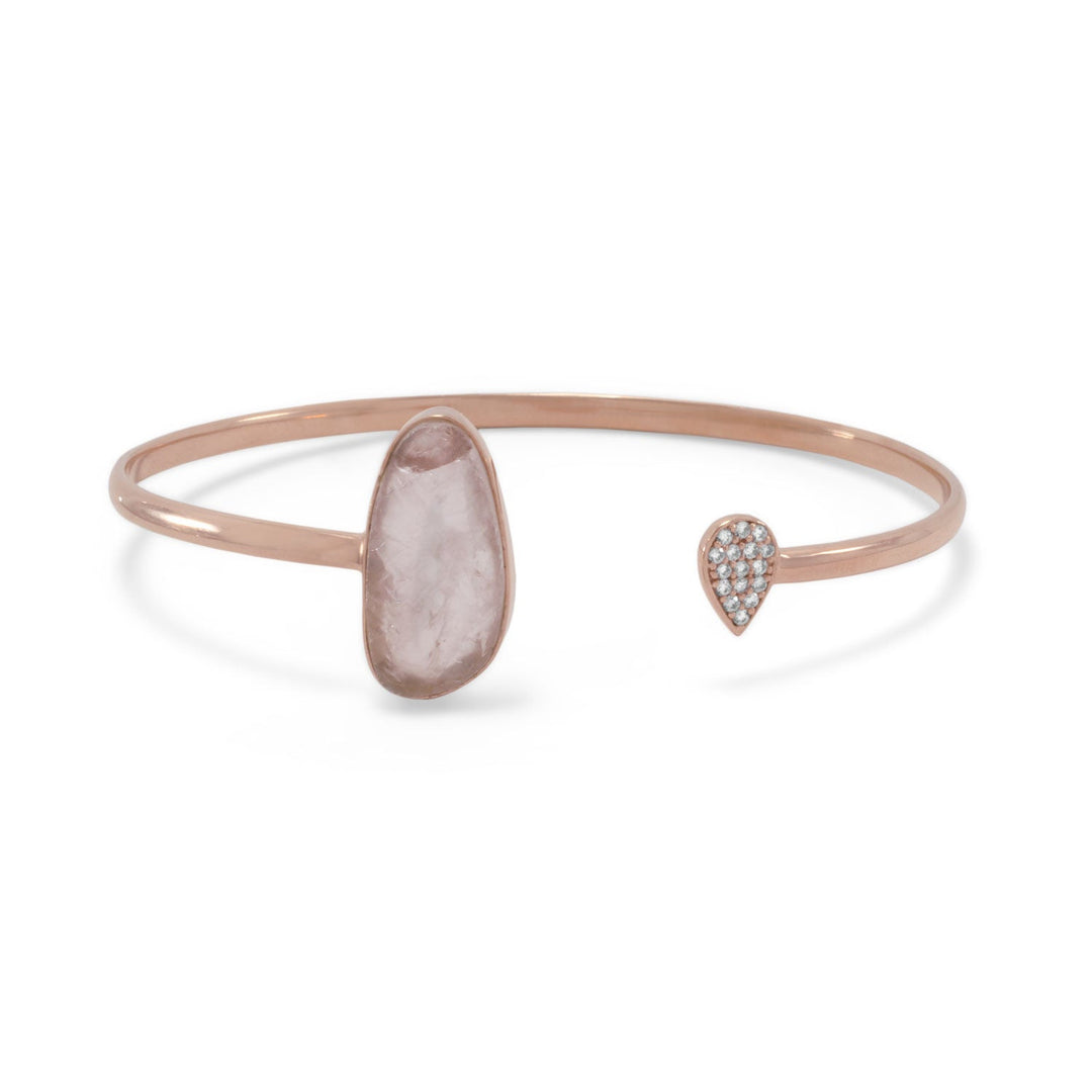 14 karat rose gold plated sterling silver cuff bracelet. The cuff features a 10mm x 21mm rough cut rose quarts on one end and a 6mm x 9mm pear drop shape with 1.2mm pave Cubic Zirconias on the opposite side. The cuff is approximately 2.8mm wide. .925 Sterling Silver