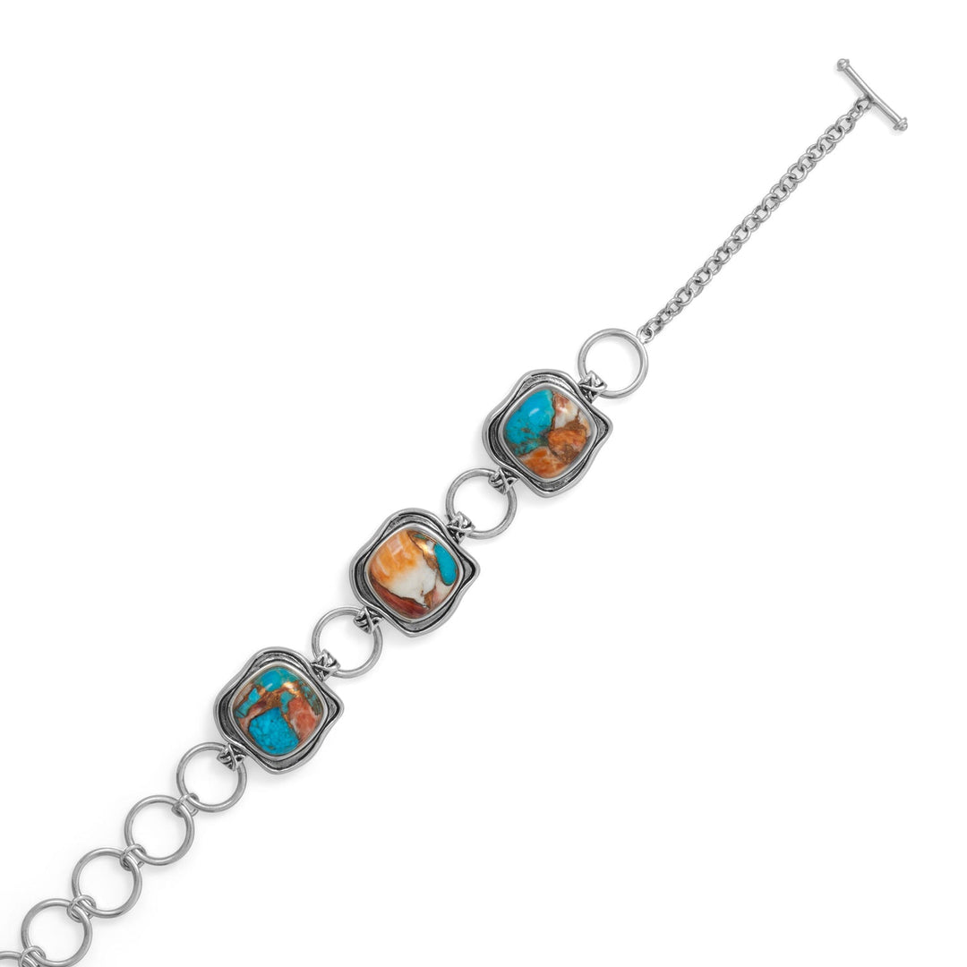 Indulge in the exquisite allure of our Simply Unique toggle bracelet, crafted from .925 sterling silver and featuring spiny oyster and turquoise cushion cut compressed stones. This versatile piece adds glamour and sophistication to any outfit, and pairs perfectly with our turquoise and spiny oyster jewelry collection. Experience the beauty and elegance of luxury jewelry design.