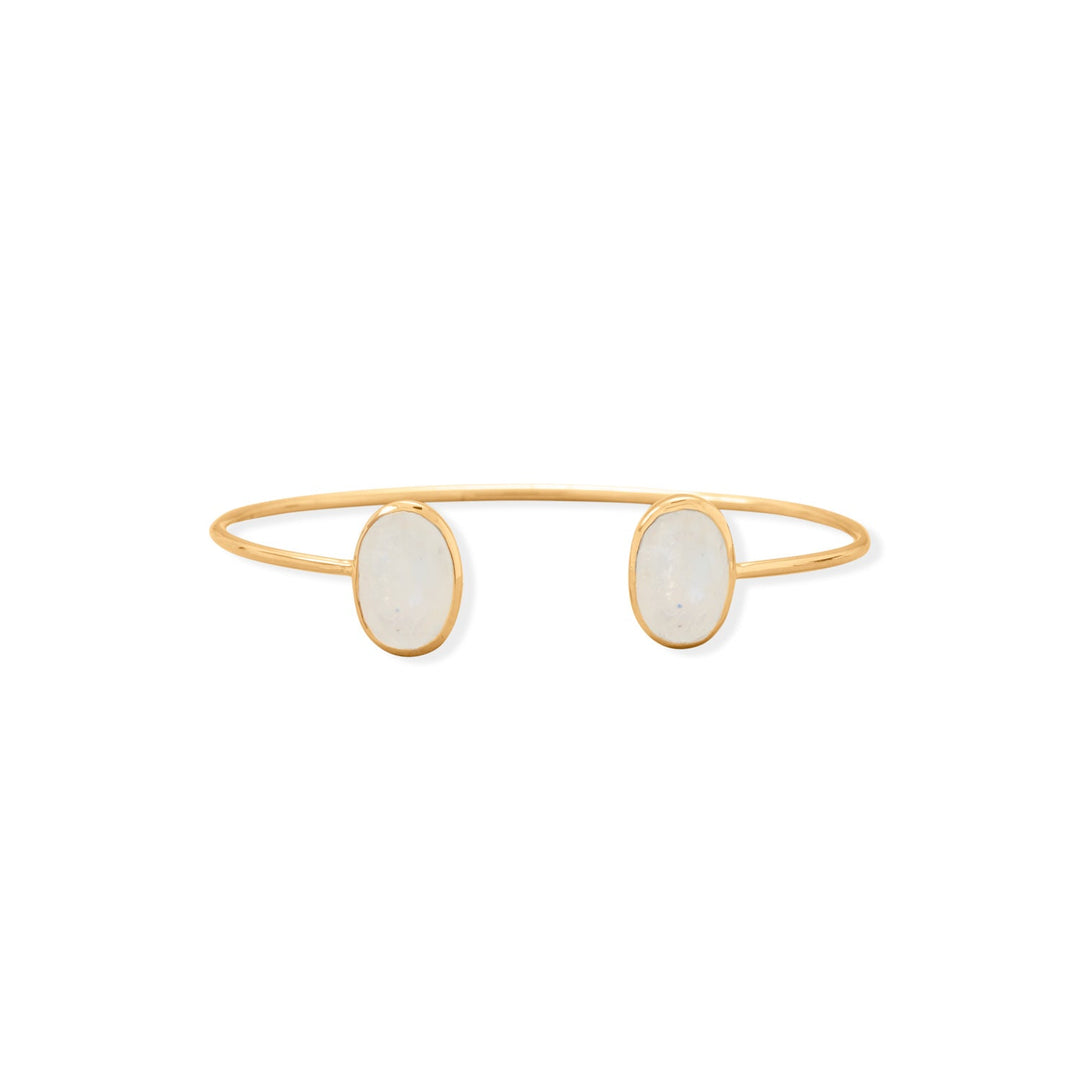 Wrist candy! 14 karat gold plated sterling silver cuff bracelet features two beautiful rainbow moonstones measuring approximately 13mm x 10mm. Cuff tubing measures 2mm round. .925 Sterling Silver 