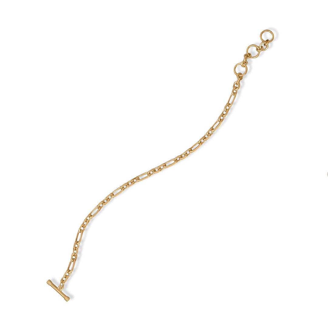 Indulge in the opulence of our 14 karat gold plated sterling silver figaro chain bracelet. A true masterpiece, crafted by our skilled artisans, this timeless piece exudes elegance and sophistication. With an adjustable toggle closure, it offers both comfort and security. Wear it alone or pair it with our matching Figaro necklaces and anklets for a complete look. Elevate your style with this luxurious and versatile bracelet, a must-have addition to any jewelry collection.