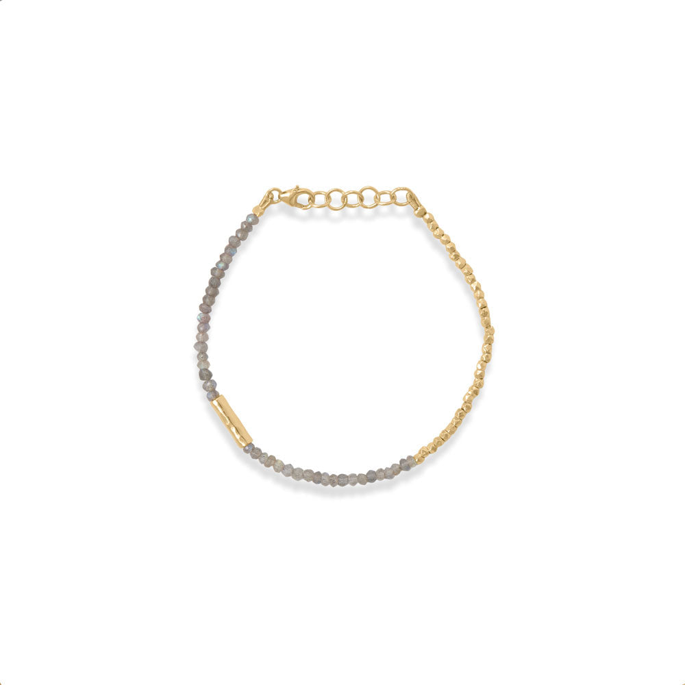 Designer details. 7" + 1" 14 karat gold plated sterling silver bracelet features 2.5mm x 2mm gold plated faceted beads, a 12.5mm offset tube bead and 2.5mm x 3mm labradorite beads. Bracelet is finished with a lobster clasp closure.  .925 Sterling Silver 