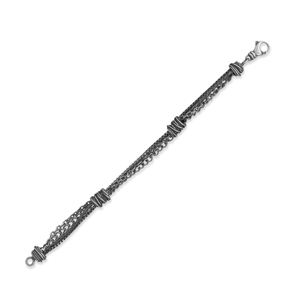 Introducing our exquisite 7" oxidized sterling silver bracelet, meticulously crafted in Italy. Adorned with a captivating fusion of box, cable, curb, and rope chains, enhanced by intricate wire wrapped details. Secured with a luxurious lobster clasp closure. Accompanied by a Certificate of Authenticity. Elevate your style with .925 Sterling Silver perfection.