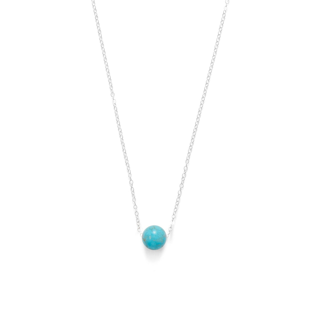 Introducing our exquisite necklace, exuding a simply classic style. Adorned with a floating 10mm dyed blue magnesite bead, delicately suspended on a 1.7mm sterling silver cable chain. Crafted from .925 sterling silver, this piece boasts both elegance and durability. The mesmerizing turquoise blue hue effortlessly complements our sterling silver and turquoise colored jewelry collection. 