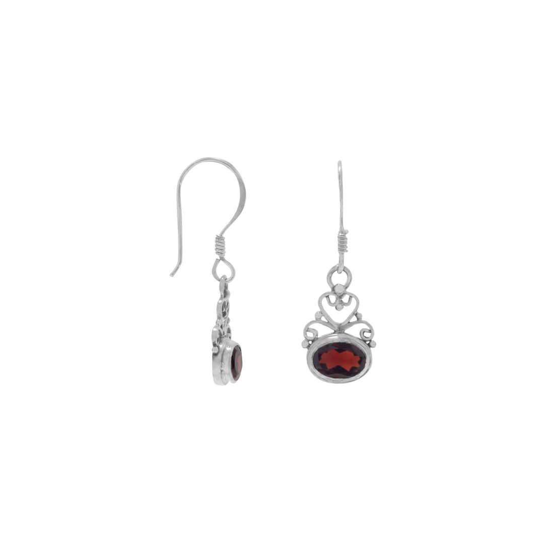 Earrings we love! Oxidized Sterling Silver Scroll Design Garnet Earrings feature a 7mm x 5mm faceted oval garnet. Earring is on french wires and have a 29mm hanging length. Hand made items will have slight variances.Made in Bali, Indonesia .925 Sterling Silver