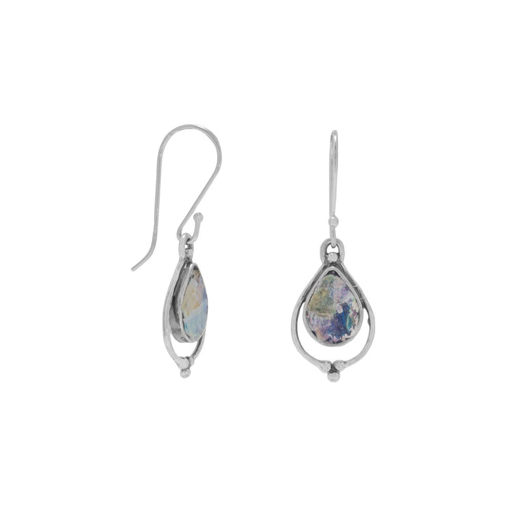 Introducing our exquisite Sterling Silver French Wire Earrings with a captivating Ancient Roman Glass drop. Delicate yet practical, these earrings boast a pear-shaped design that showcases the mesmerizing beauty of Roman glass. Crafted with .925 Sterling Silver, they come with a Certificate of Authenticity, ensuring their genuine quality. Complete your ensemble by pairing them with our other stunning sterling silver and Roman glass jewelry pieces. A must-have for the discerning connoisseur.