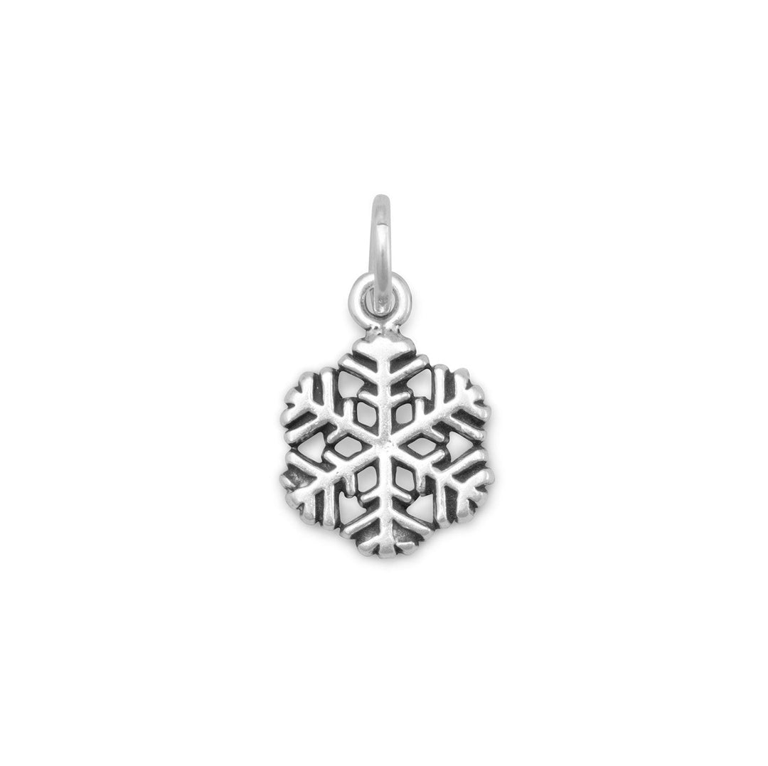 Dainty oxidized sterling silver snowflake charm measures 9.5mm in diameter. .925 Sterling Silver